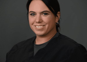 Headshot of Kristie Engler-Lynaugh , a professional dentist, with a welcoming smile in a clinical setting.