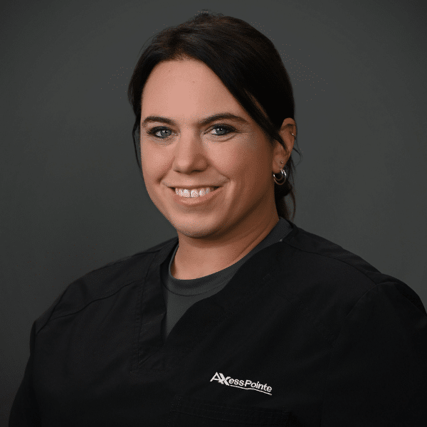 Headshot of Kristie Engler-Lynaugh , a professional dentist, with a welcoming smile in a clinical setting.